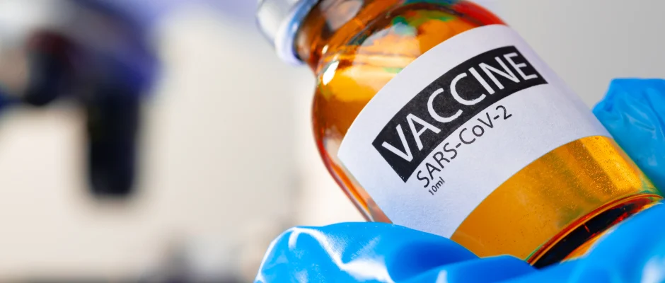 COVID-19 vaccine bottle representing South Africa travel vaccination requirements