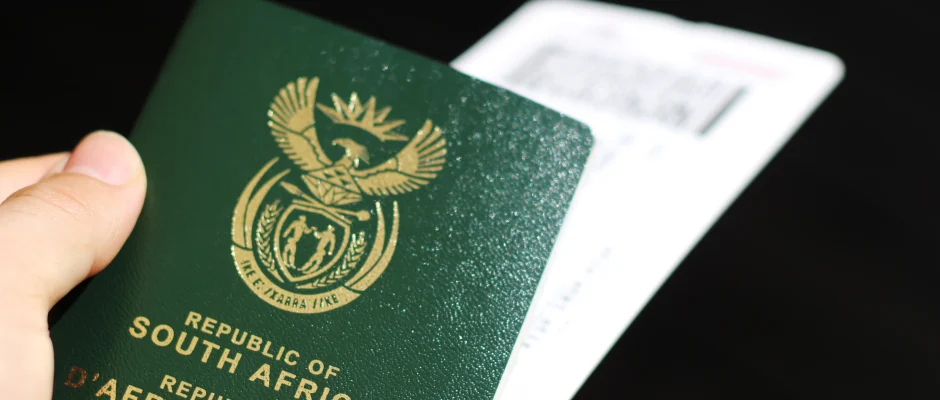 Man holding a South African passport for a guide on how to get a South African passport