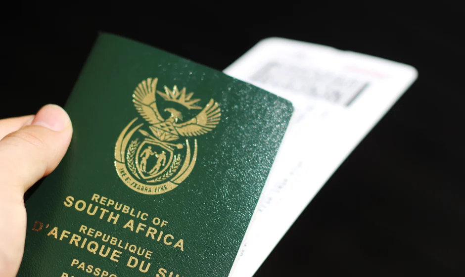Man holding a South African passport for a guide on how to get a South African passport